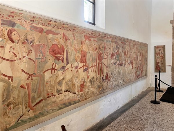 Along the great fresco of the knights, time suspended between the centuries.