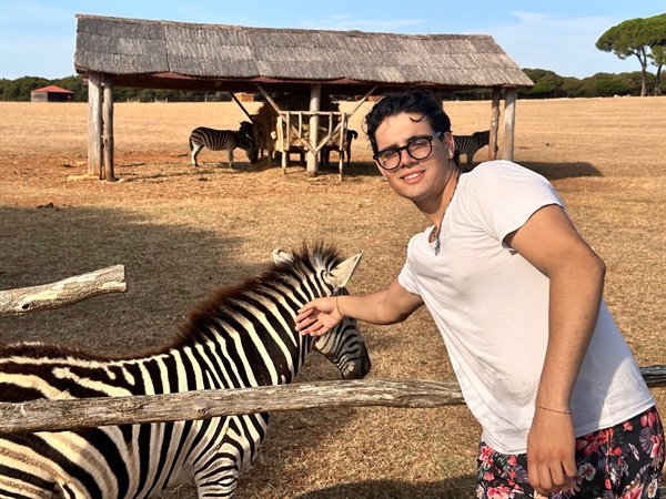 I stroke a zebra at the safari, a golden day between savannah and smiles.