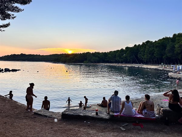 Sunset over the cove: dips at dusk and skies turning to gold.