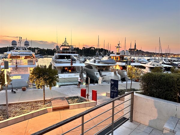Golden sunset over the port of Rovinj, yachts and relaxation by the sea.