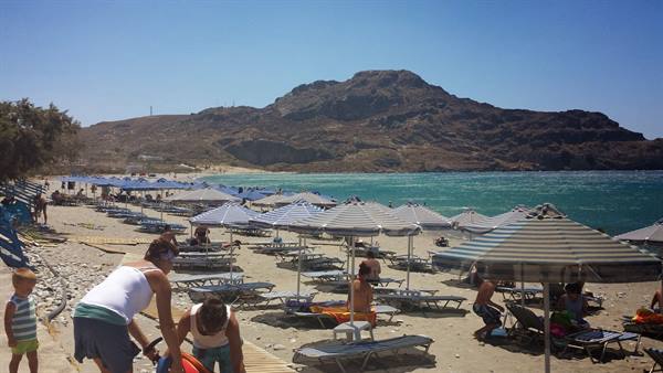 A day of sun and turquoise sea among the umbrellas of Damnoni, Crete.