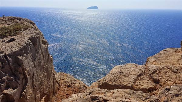 From the cliff, the endless sea and an island on the horizon: pure wonder.