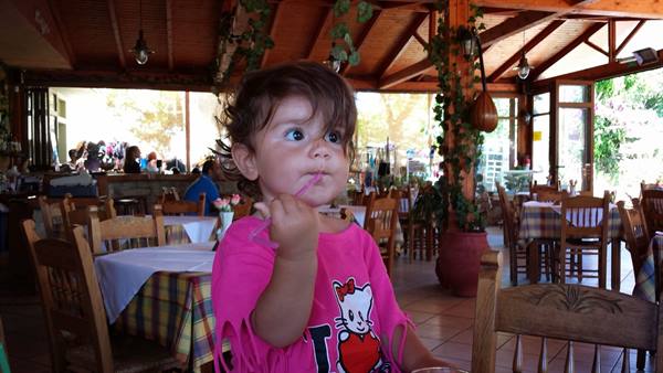 Lunch in a Greek taverna, with our curious little one in tow