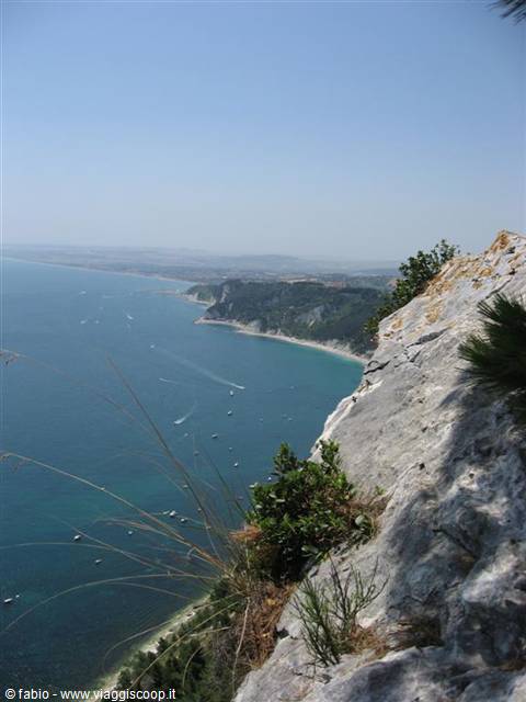 Limestone rocks and shrubs above the turquoise sea of Monte Conero