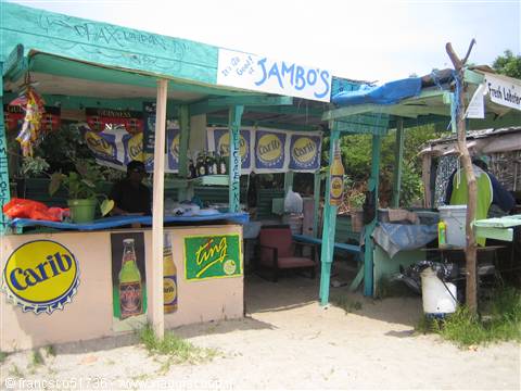 Green wooden shack with Jambo's sign and Carib beer advertisements
