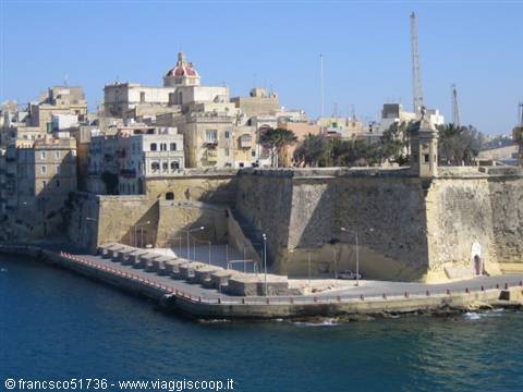 Valletta limestone bastions above the harbour, church with red dome