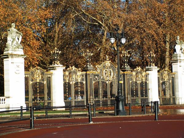 Canada Gate in London, gilded ironwork on marble pillars among autumn trees