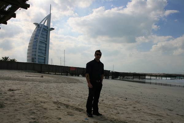 Man standing on the sand in front of Burj Al Arab, Dubai