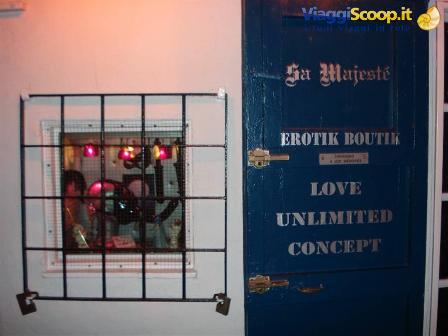 Blue Erotik Boutique door with barred window glowing red light inside