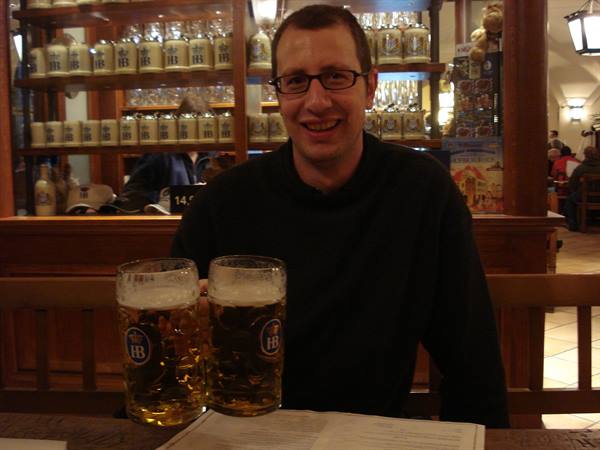 Man with two HB beer steins at the Hofbräuhaus in Munich