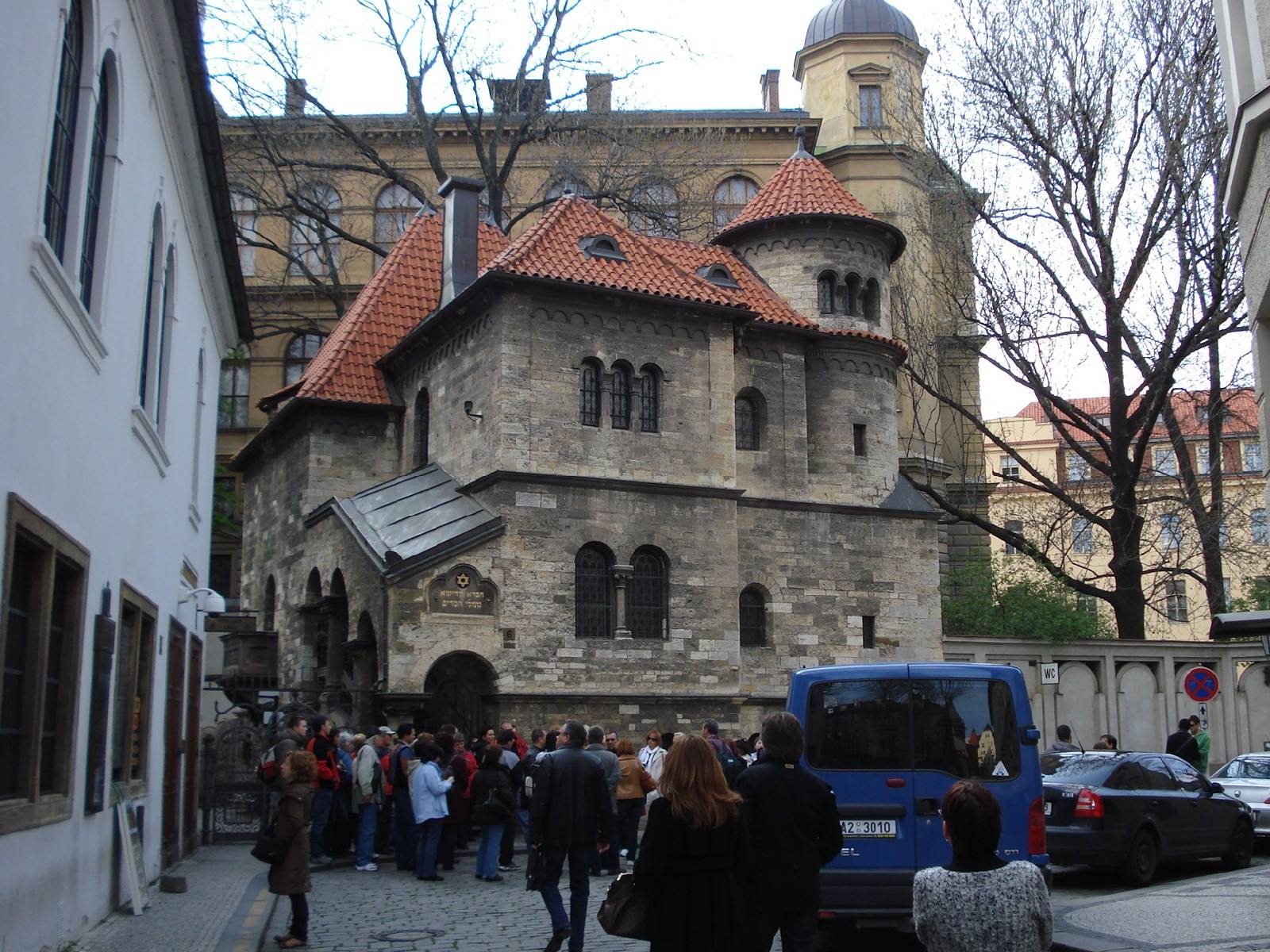 Tourists queueing outside the stone Klausen Synagogue, Prague