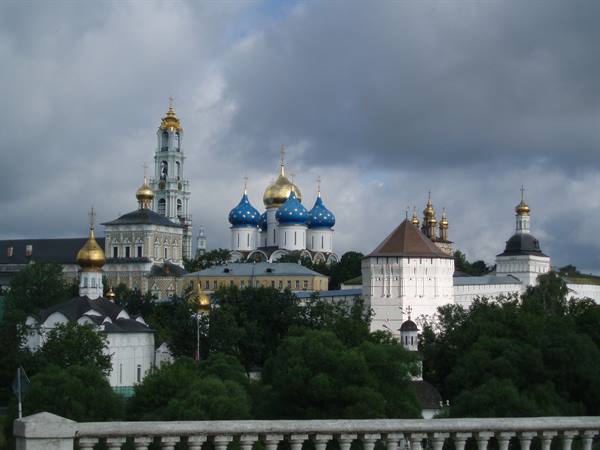 Blue and golden domes of the Trinity Lavra in Sergiev Posad under clouds