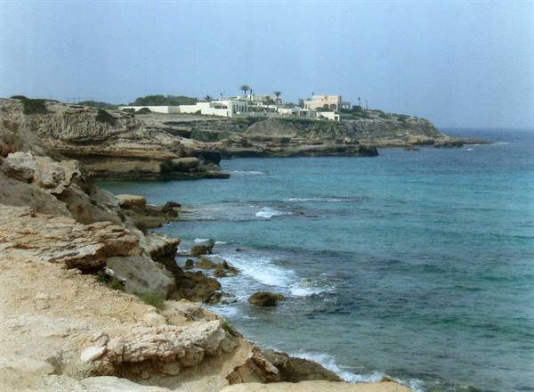 Limestone rocks and white houses above the turquoise sea