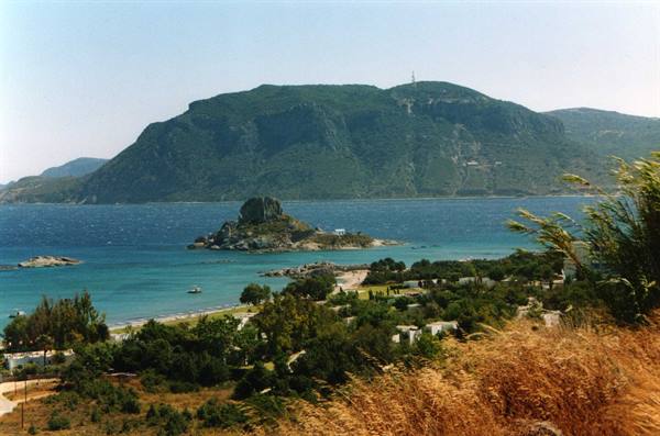 turquoise Kefalos bay with rocky islet and green mountains on Kos