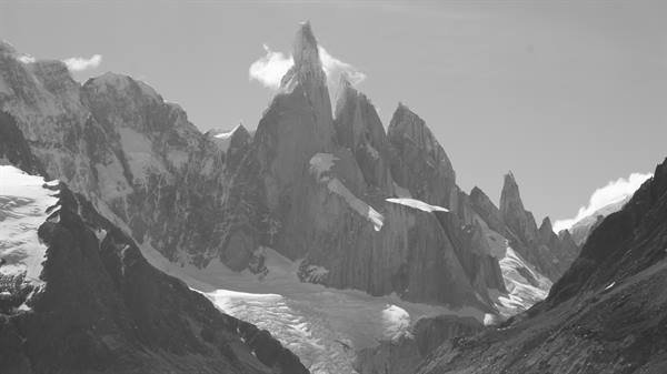 Snow-covered granite spires of Cerro Torre above the glacier, black and white