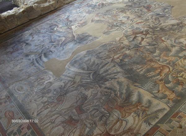 Ancient Roman hunting mosaic with animals, colored stone tesserae on old floor