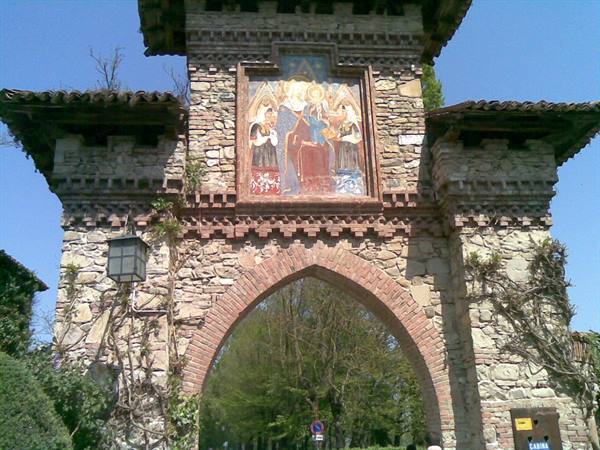 Stone gateway with mosaic of Madonna and saints, Grazzano Visconti