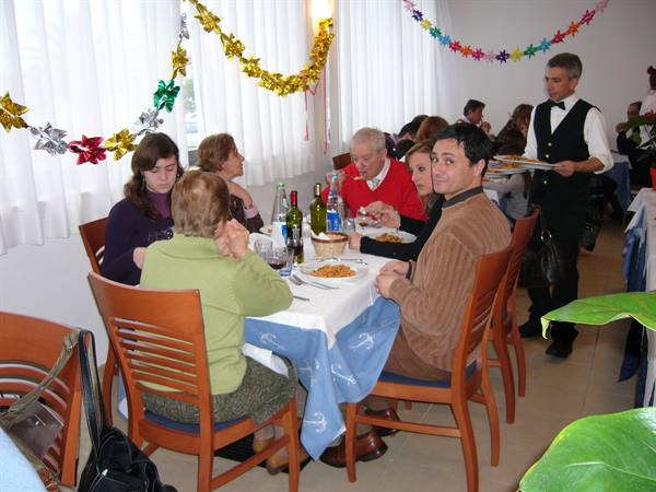 Family dining at a Viareggio restaurant, Christmas decorations, waiter carrying tray