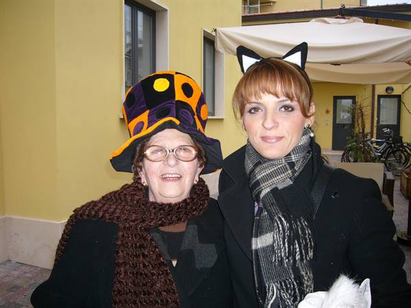 Elderly woman in polka-dot hat and young woman with cat ears in Viareggio