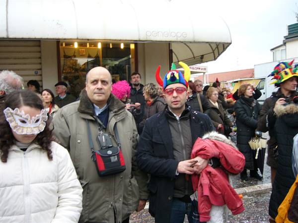 Masked crowd under the Penelope bar awning in Viareggio during carnival