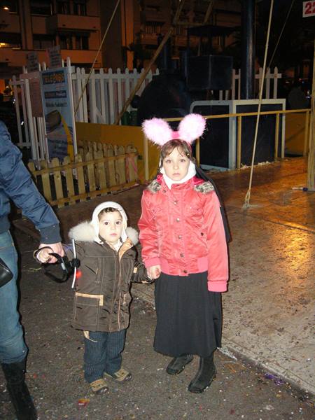 Girl with pink bunny ears and little boy at Viareggio carnival