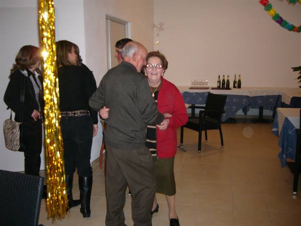 Elderly couple dancing in a decorated party hall in Viareggio