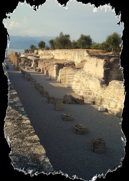 Roman ruins of Grotte di Catullo in Sirmione, limestone walls in sunlight by Lake Garda