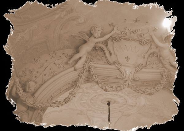 White stucco cherubs decorating the vaulted ceiling of a baroque palace