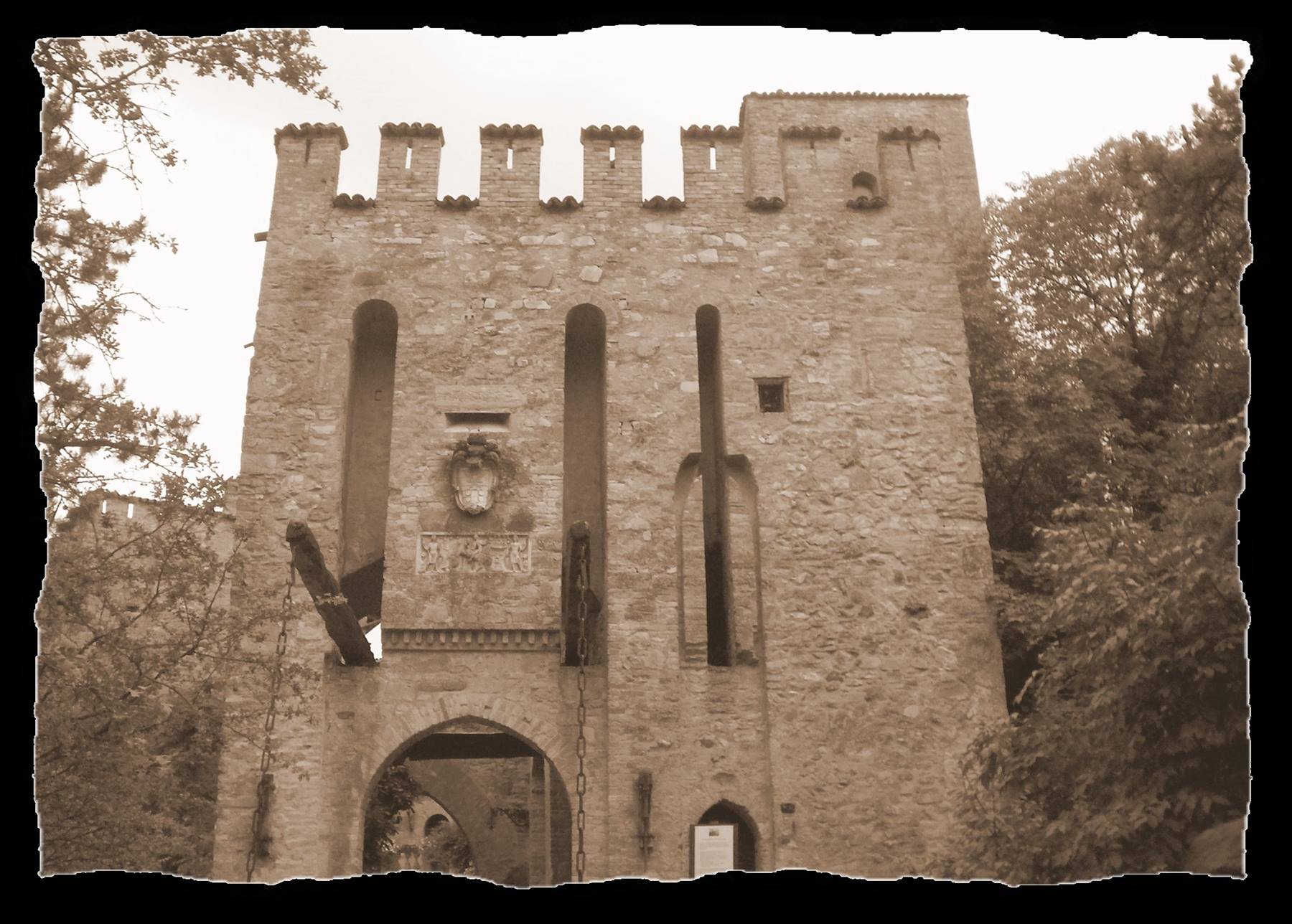 Stone fortified gate with battlements, drawbridge chains, sepia tones