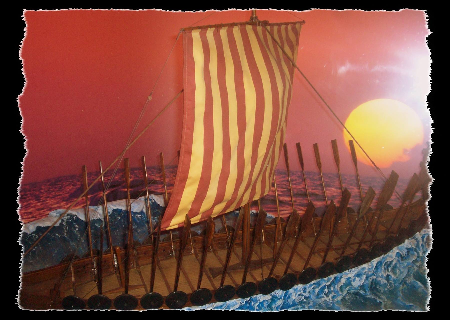 Model of a Viking ship with striped sail and rows of oars