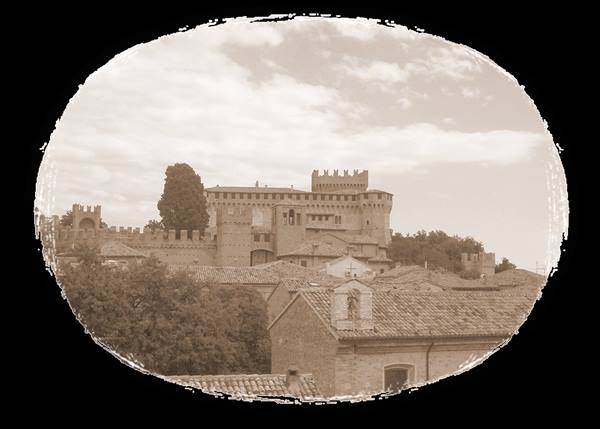 Medieval brick castle with battlements above tiled rooftops, sepia tone
