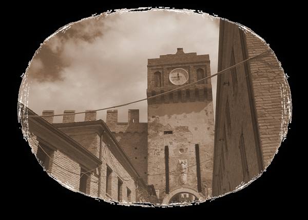 Crenellated brick clock tower rising between medieval houses, sepia photo
