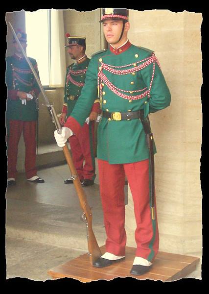 Honor guard in green and red uniform holding rifle, San Marino