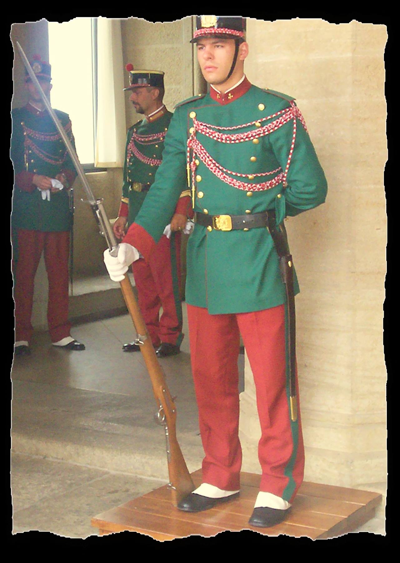 Honor guard in green and red uniform holding rifle, San Marino