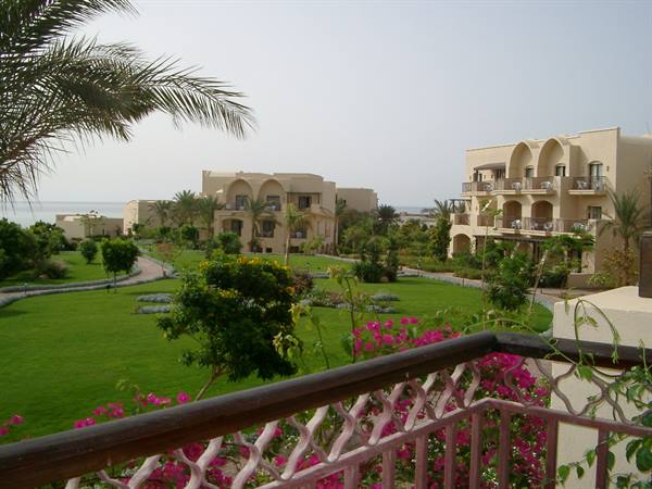 Red Sea resort: flowered garden, palm trees, Arabic-style hotel among greenery
