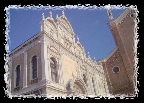 Marble facade of San Zaccaria church in Venice under blue sky