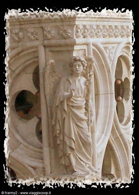 Marble statue of announcing angel on the facade of Orvieto Cathedral