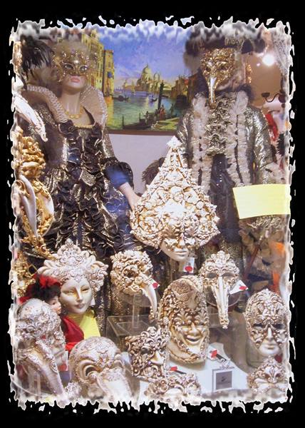 Shop display of golden Venetian masks, costumed mannequins and lagoon painting