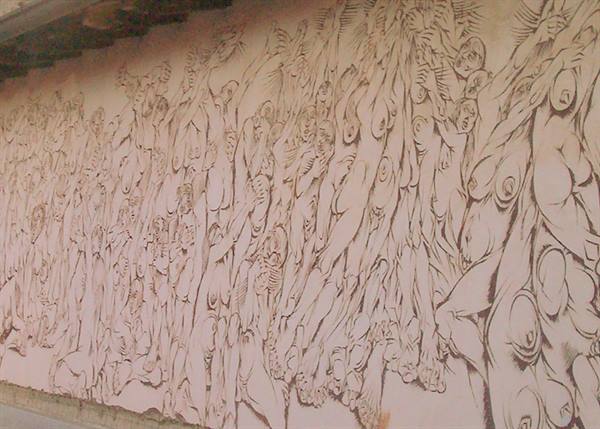 Wall painted with stylized nude figures in brown on light plaster