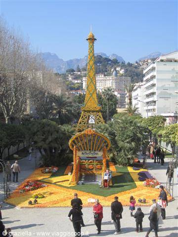 Citrus Eiffel Tower sculpture at Menton Lemon Festival, visitors strolling nearby