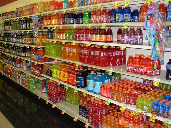 Supermarket shelves stocked with colorful Gatorade bottles and yellow price tags