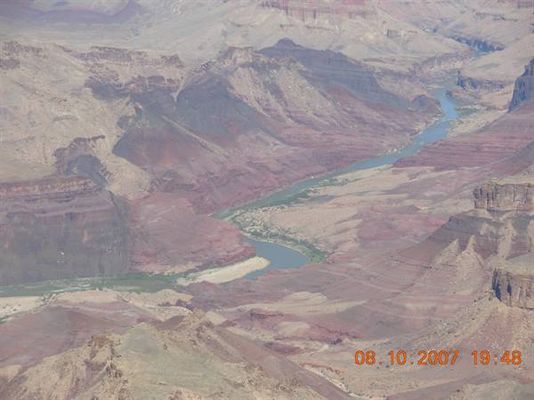 The Colorado River winds through the red rocks of Grand Canyon