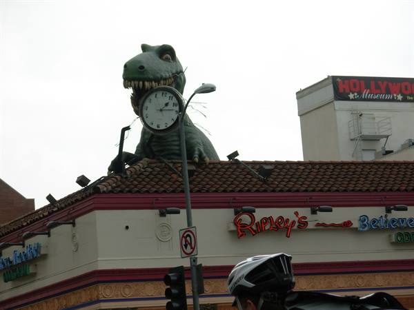 Green T-Rex statue with clock on Ripley's museum rooftop in Hollywood