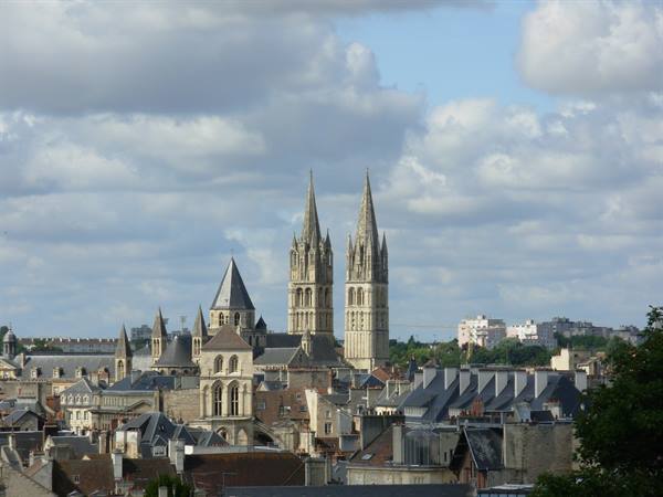 The Gothic twin spires of Saint-Pierre cathedral rise above Caen rooftops