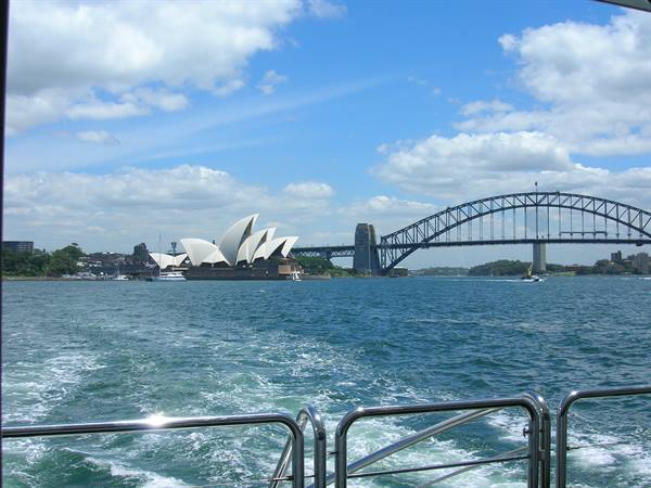 Sydney Opera House and Harbour Bridge seen from a ferry over wake