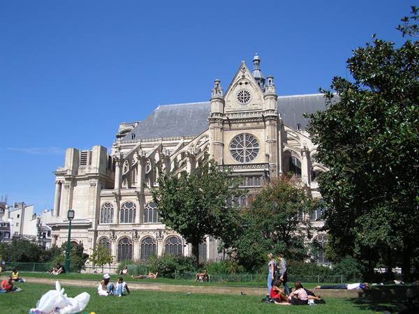 People relaxing on the lawn in front of Saint-Eustache church in Paris