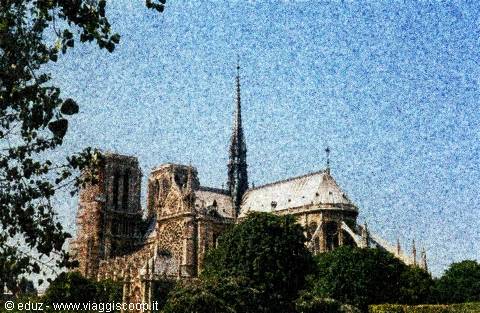 Notre-Dame Cathedral in Paris, gothic stone and spire among trees