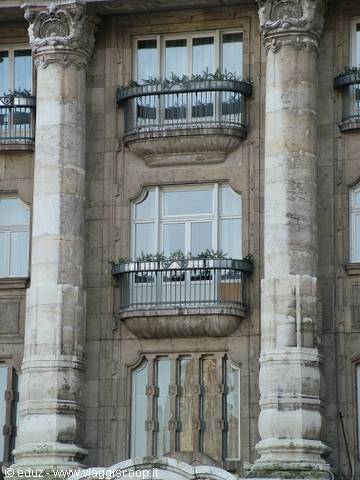 Stone facade with spiral columns and wrought iron balconies