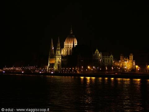 Budapest Parliament illuminated at night, reflected in the Danube