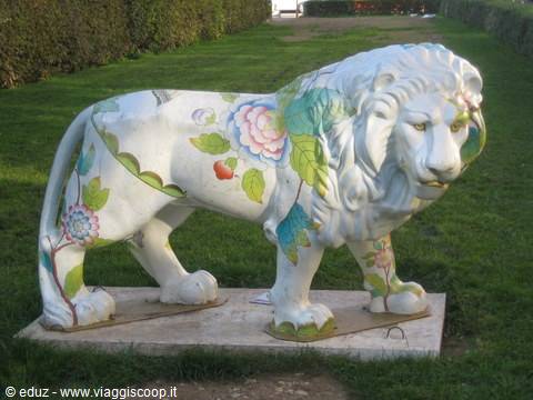 Lion statue painted with flowers on the lawn, Boboli Gardens